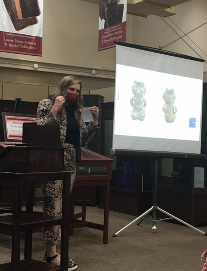 WVU Teaching Assistant Professor Megan Leight lecturing on a Costa Rican female effigy sculpture in the “Preserved in Clay and Stone: Celebrating the History of Ancient Latin America” exhibition, which is currently on display at the Louise Pettus Archive 