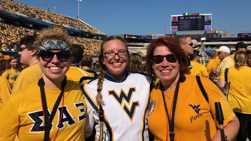 Wanda Hembree (right) with her daughters at WVU stadium
