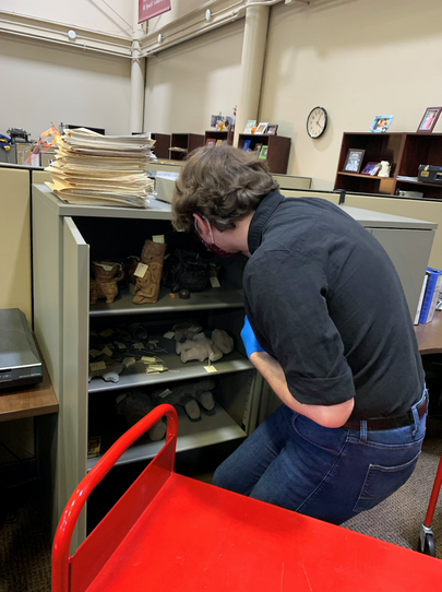 WVU Honors Art History student Samuel Hensley peers into the temporary holding for the Salazar Collection at the Louise Pettus Archives, Winthrop University, Rock Hill, South Carolina.