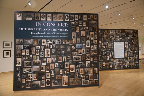 The introduction wall for "In Concert" at the Art Museum of WVU. The wall features a gallery of photos from different time periods